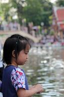 little asian girl on the background of the lake