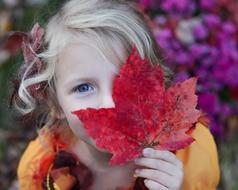 girl with autumnal red leaf