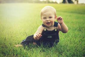 smiling baby boy on the meadow