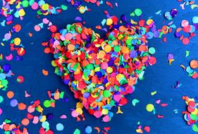 Colorful Heart shape at blue background, Confetti