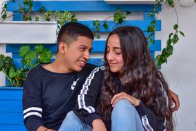 romantic couple in love on a blue bench