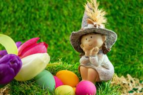 doll, bouquet of tulips and colorful easter eggs