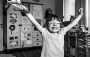 black and white photo of a girl with a toy gun