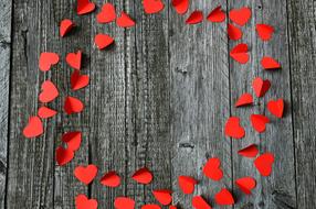 red paper hearts on a wooden board