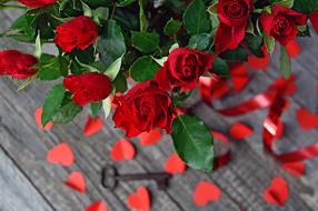 bouquet of red roses, key and paper hearts