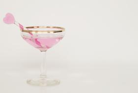 glass of pink champagne with decoration