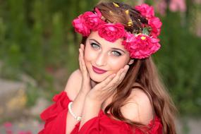 girl with a wreath of red flowers on her head