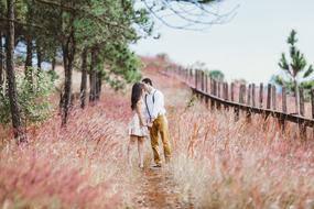 kiss of happy newlyweds in nature
