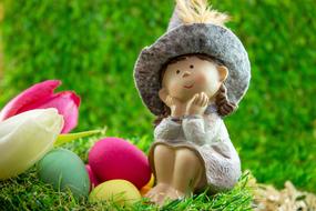 funny easter figurine on the grass on a blurred background