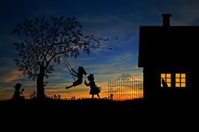 Silhouettes of the children playing near the house