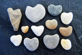 stones in the shape of hearts on a black background