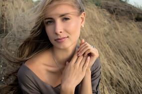 photo of a blonde on a background of hay