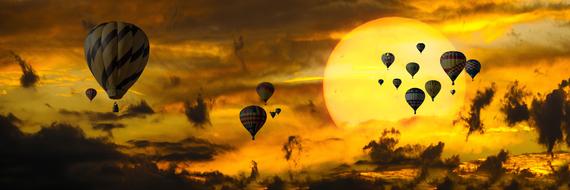 panoramic view of hot air balloons on sky at sunset