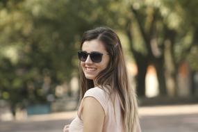 cute girl in sunglasses is smiling