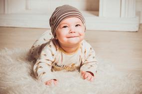 cute newborn lies on a fluffy carpet