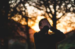 young man with hands on face outdoor