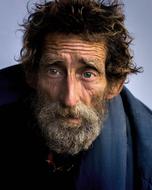 photo of an elderly bearded homeless man