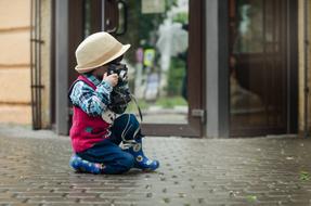 Camera Boy with Hat near the glass door