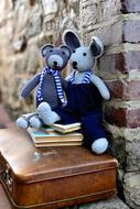 two plush mice on a suitcase