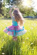 Little Girl Twirling in Dance on blooming meadow