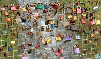 multi-colored metal locks of lovers on a lattice