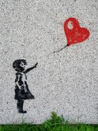 painted girl with a balloon on the wall
