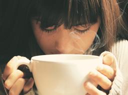 girl enjoys hot coffee