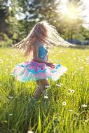 Little Girl Twirling in dance on meadow