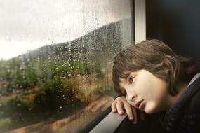 Little Boy near wet window
