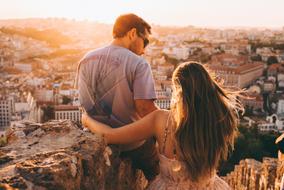 couple in love on a background of a panorama of the city at sunset