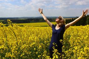 joyful woman on yellow rape field