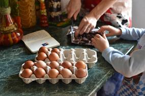 brown eggs in cardboard boxes on the table