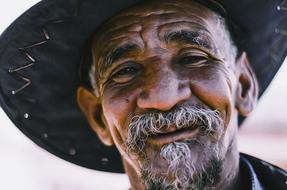 happy man with beard and hat