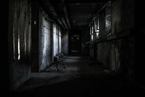 black and white photo of a gloomy interior of an abandoned factory