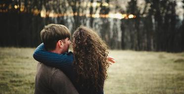 couple in love on an autumn field in the evening