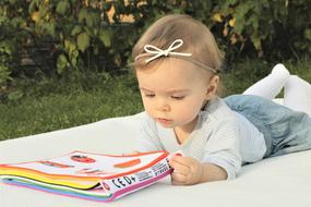Child Baby with booklet on blanket