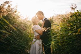 photo of newlyweds in thickets of grass