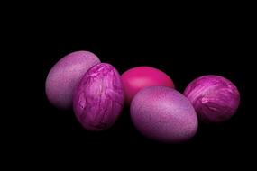 purple Easter eggs on the black background