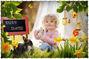 Portrait of the cute, smiling, blonde child among the beautiful and colorful Easter frame with the Easter bunny