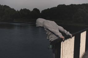 man on bridge over river