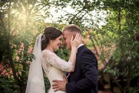 photo of newlyweds on a background of green trees