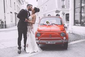 Wedding Pair kiss red car