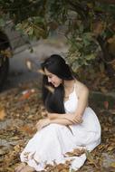 pretty Girl sits on pavement at fall