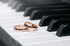 wedding rings on the piano keyboard