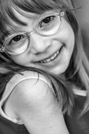 portrait of a smiling girl with glasses