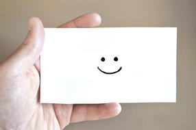 hand and smiley on blank white card