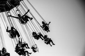 silhouettes of people on a chain carousel