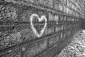 heart drawn in chalk on a brick wall