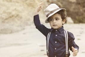 Child boy in vintage white hat outdoor