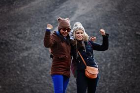 Friends, two Happy Girls in winter clothe posing outdoor